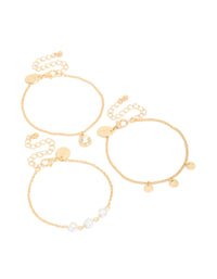 Featuring a 3-pack of gold charm bracelets accented with pearls, discs, and a solitaire-cut diamante front view - link has visual effect only