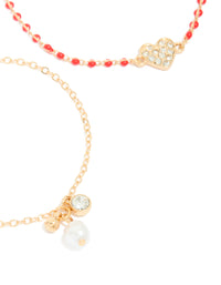 Featuring gold red beaded diamante heart and pearl bracelets in a 2-pack with charm accents close up view - link has visual effect only