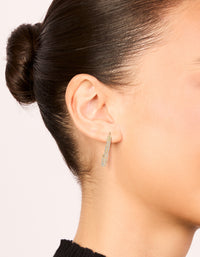 Featuring gold diamante safety pin hoop earrings with sparkling stones in an on ear view - link has visual effect only