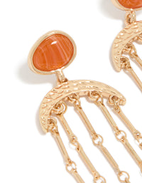 Featuring statement style, these gold cat eye stone drop earrings showcase beads accents, and charm details in coral and orange close up view - link has visual effect only