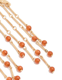 Featuring statement style, these gold cat eye stone drop earrings showcase beads accents, and charm details in coral and orange close up view - link has visual effect only