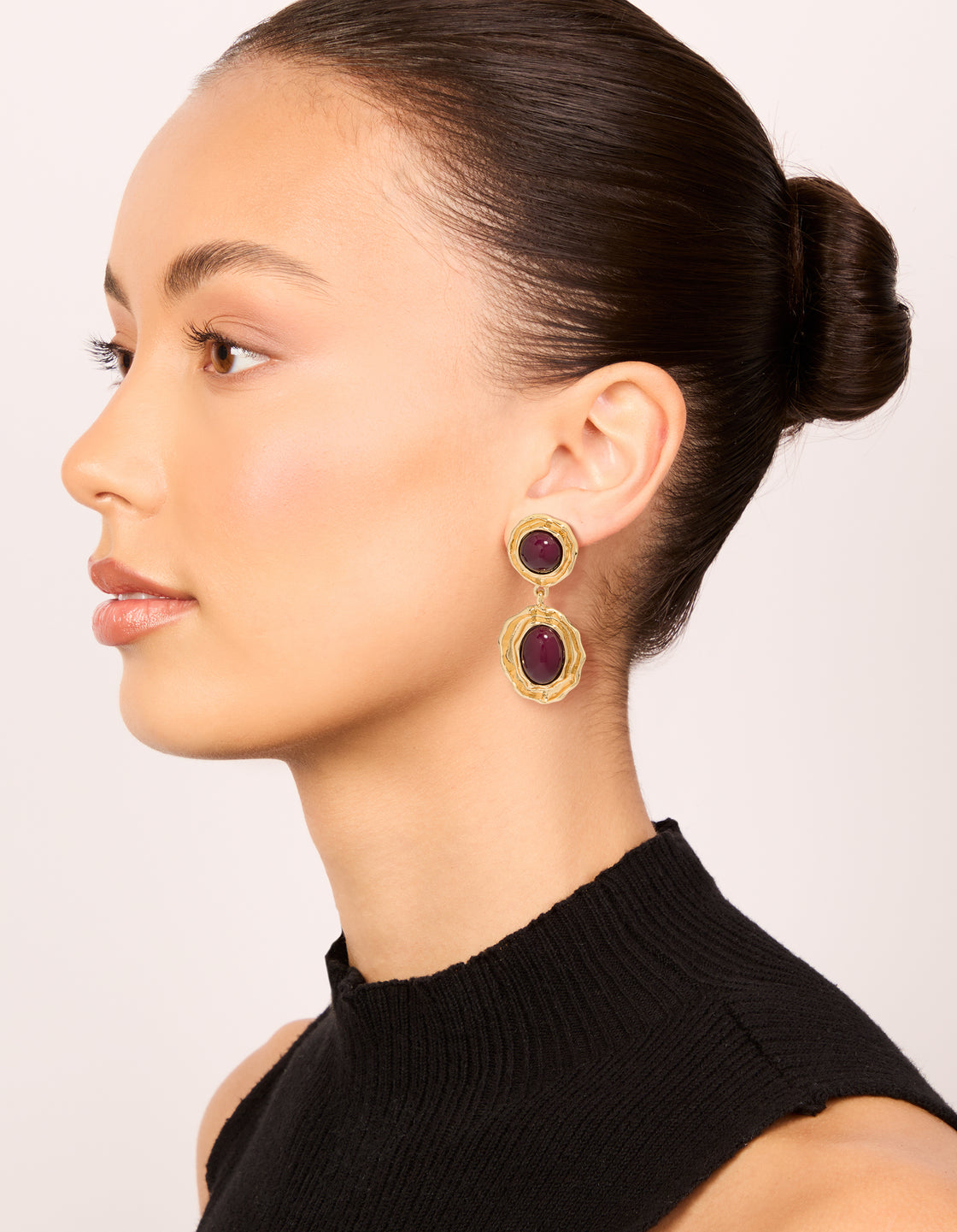 Presenting gold double burgundy resin drop earrings crafted from statement materials in maroon on model view