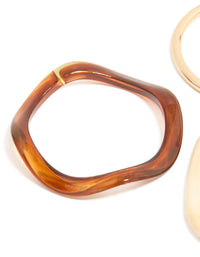 Crafted from resin, thin bangle in gold tones close up view - link has visual effect only