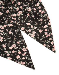 Designed with floral printed fabric in black and pink, this statement scarf scrunchie is shown in detail view - link has visual effect only