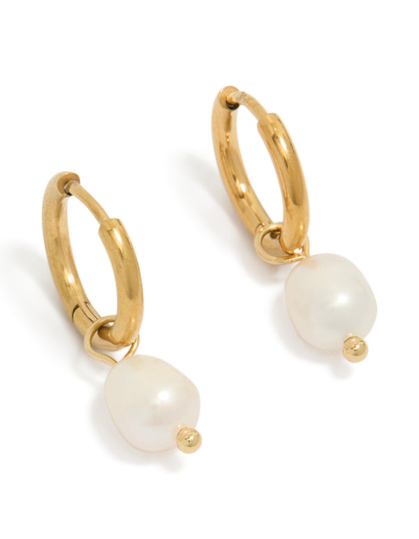 Featuring waterproof gold plated stainless steel freshwater pearl huggie earrings in ivory front view
