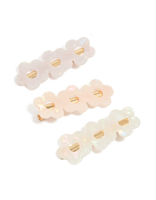 Showcasing acrylic triple flower hair clips in a 3-pack in ivory, pink, and gold detail view