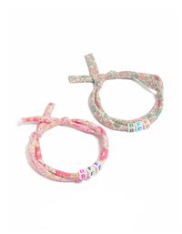 Showcasing beaded floral script 2-pack fabric bracelets in pink, beige, light green, and white front view - link has visual effect only
