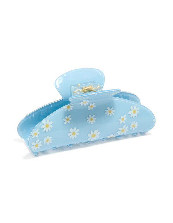 Crafted with a kids blue daisy printed arch claw clip showcasing floral pattern in light blue, white, and yellow side view