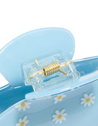 Designed with a kids blue daisy printed arch claw clip displaying floral pattern in light blue, white, and yellow detail view - link has visual effect only