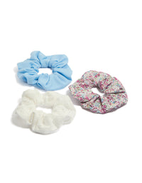 Showcasing kids floral print and broderie fabric scrunchies in a 3-pack featuring light blue, white, pink, and light green front view - link has visual effect only