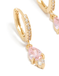Featuring dainty huggie earrings with pink cubic zirconia, gold plated finish close up view - link has visual effect only
