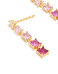 Showcasing gold pink cubic zirconia gradient drop earrings featuring statement design close up view - link has visual effect only