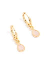 Showcasing statement huggie earrings with pink cubic zirconia teardrop in gold plated finish front view - link has visual effect only