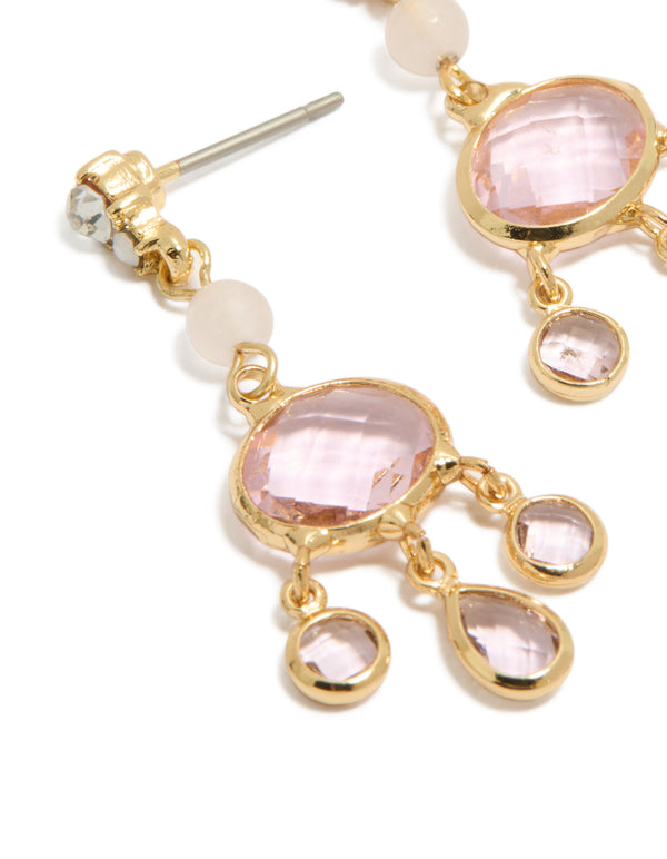 Featuring gold plated clear bead and diamante drop earrings with charm details close up view