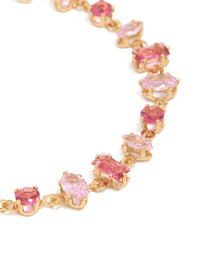 Featuring a gold large pink multi-cut cubic zirconia tennis bracelet close up view - link has visual effect only
