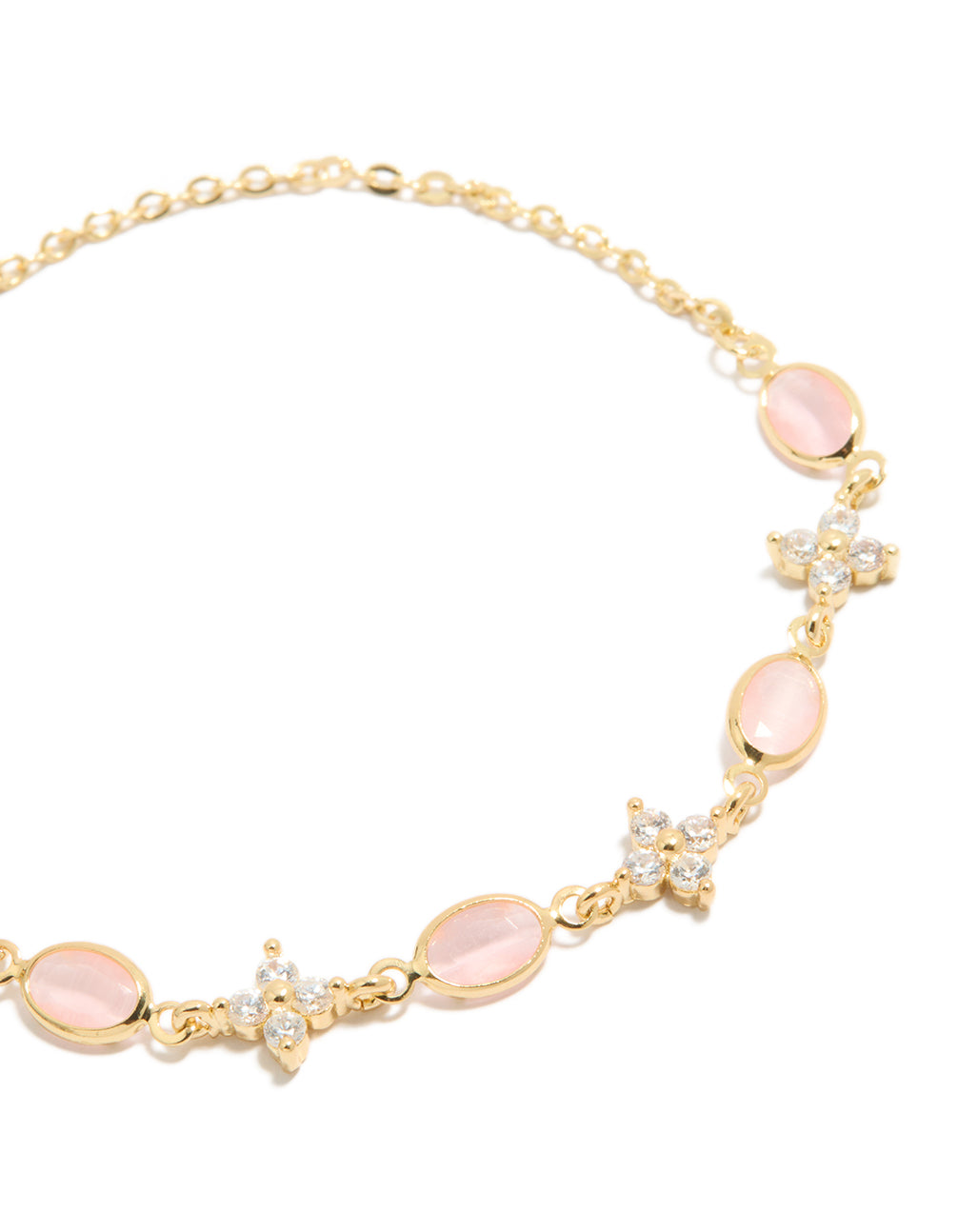 Detailed view of gold plated toggle bracelet, oval pink stones and cubic zirconia flower embellishments close up view