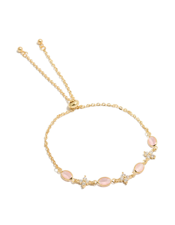 Showcasing a gold plated bracelet with floral cubic zirconia and oval pink stones in a front view