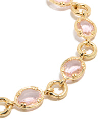Highlighting a gold plated bracelet with large pink cubic zirconia stones close up view - link has visual effect only