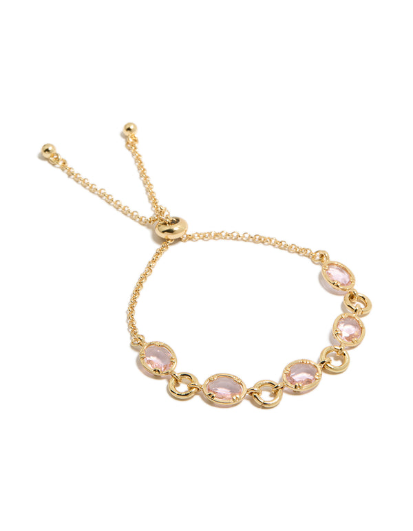 Showcasing a gold plated bracelet featuring large pink cubic zirconia stones front view
