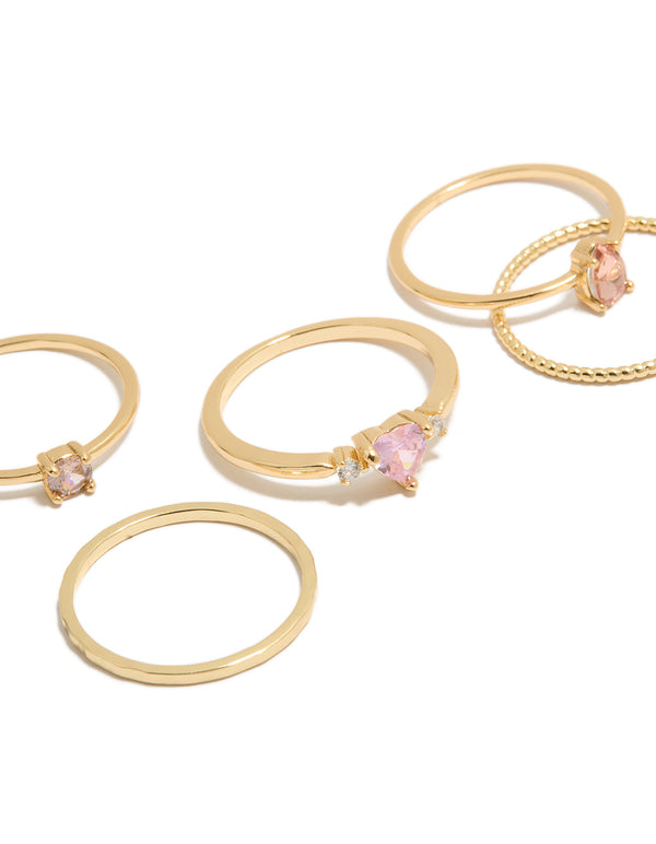 Showcasing gold plated pink heart cubic zirconia and molten rings in a 5-pack with crystal details close up view