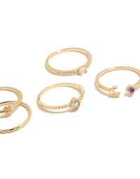 Highlighting gold celestial cubic zirconia rings 5-pack with sun, moon and oval stone cut in a dainty style close up view - link has visual effect only