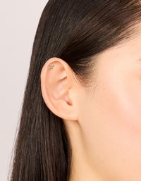 This titanium gold plated cubic zirconia multi shaped single flat back stud showcases elegant placement on ear view - link has visual effect only