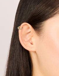 Featuring vine design gold plated titanium clicker ring with blue cubic zirconia on ear view - link has visual effect only