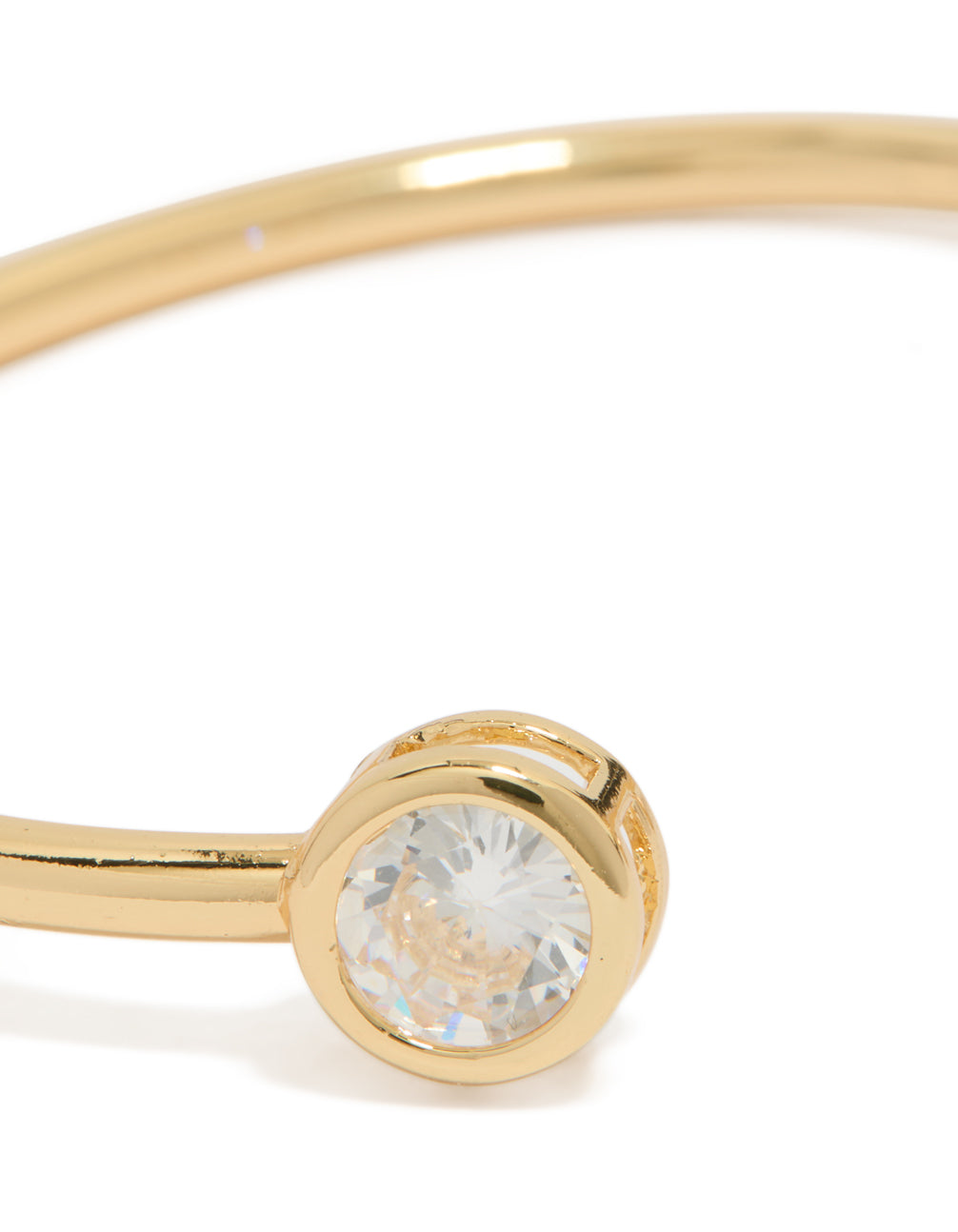 This gold plated open wrist cuff with cubic zirconia in clear close up view