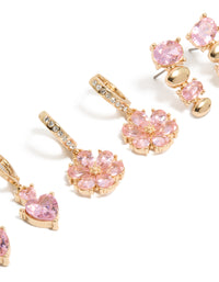 Showcasing gold pink diamante flower and heart huggie earrings in a 3-pack with oval stone cut close up view - link has visual effect only