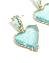 Presenting statement heart drop earrings crafted from glass stone in blue and gold tones close up view - link has visual effect only