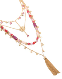 Beautifully crafted gold purple and pink beaded tassel layered necklace with charm disc pendant featuring statement style close up view - link has visual effect only