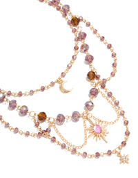 Featuring a gold purple beaded celestial draped layered necklace with charm pendant moon and star close up view - link has visual effect only