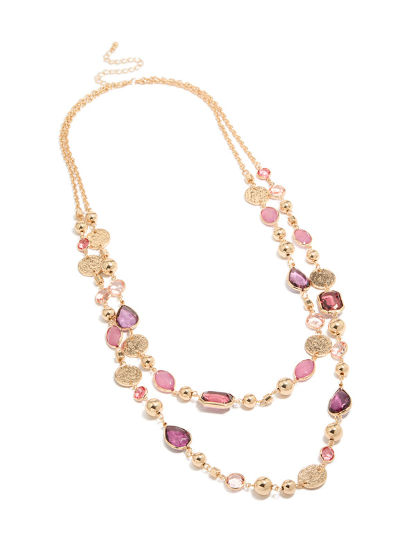 Elegantly designed gold disc and pink beaded layered long necklace with charms details in coral and purple accents in a chunky style front view