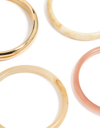 Featuring gold and pink acrylic bangles in a 4-pack set close up view - link has visual effect only