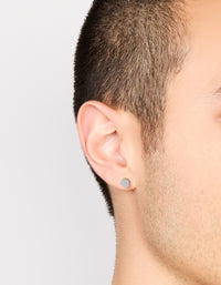 Featuring mens waterproof stainless steel round flat back stud earrings in silver and black on ear view - link has visual effect only