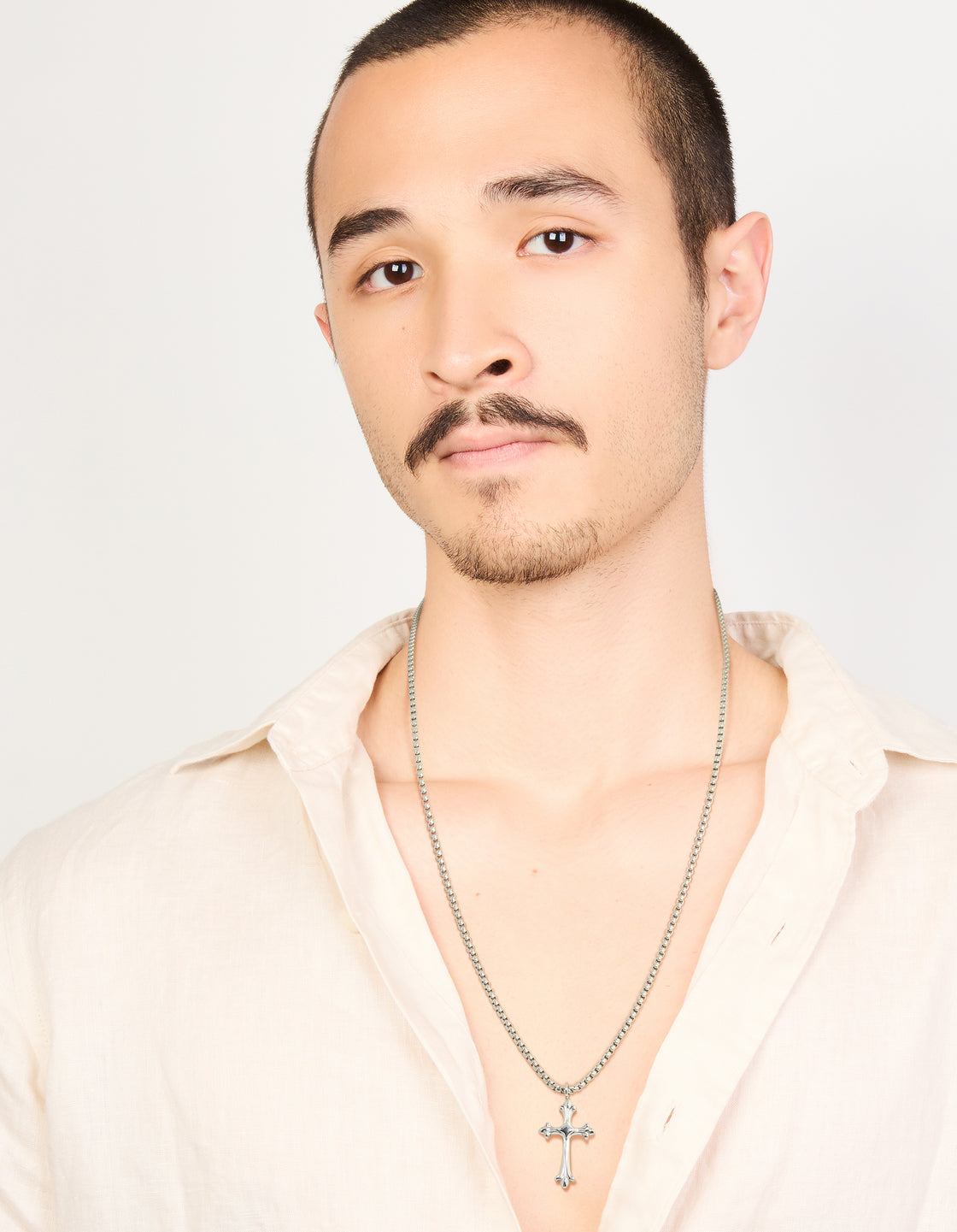 Designed with a pendant, this men’s waterproof stainless steel gothic cross necklace features a sleek silver finish, beautifully showcased on a model