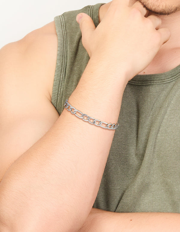 Featuring a mens waterproof stainless steel figaro chain bracelet in silver on wrist view
