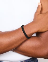Featuring a mens waterproof black coated stainless steel and PU leather braided bracelet on wrist view - link has visual effect only