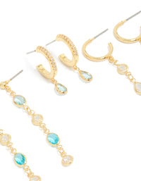 Showcasing gold plated blue and clear cubic zirconia stacking earrings 4-pack with crystal huggie and stud closures close up view - link has visual effect only