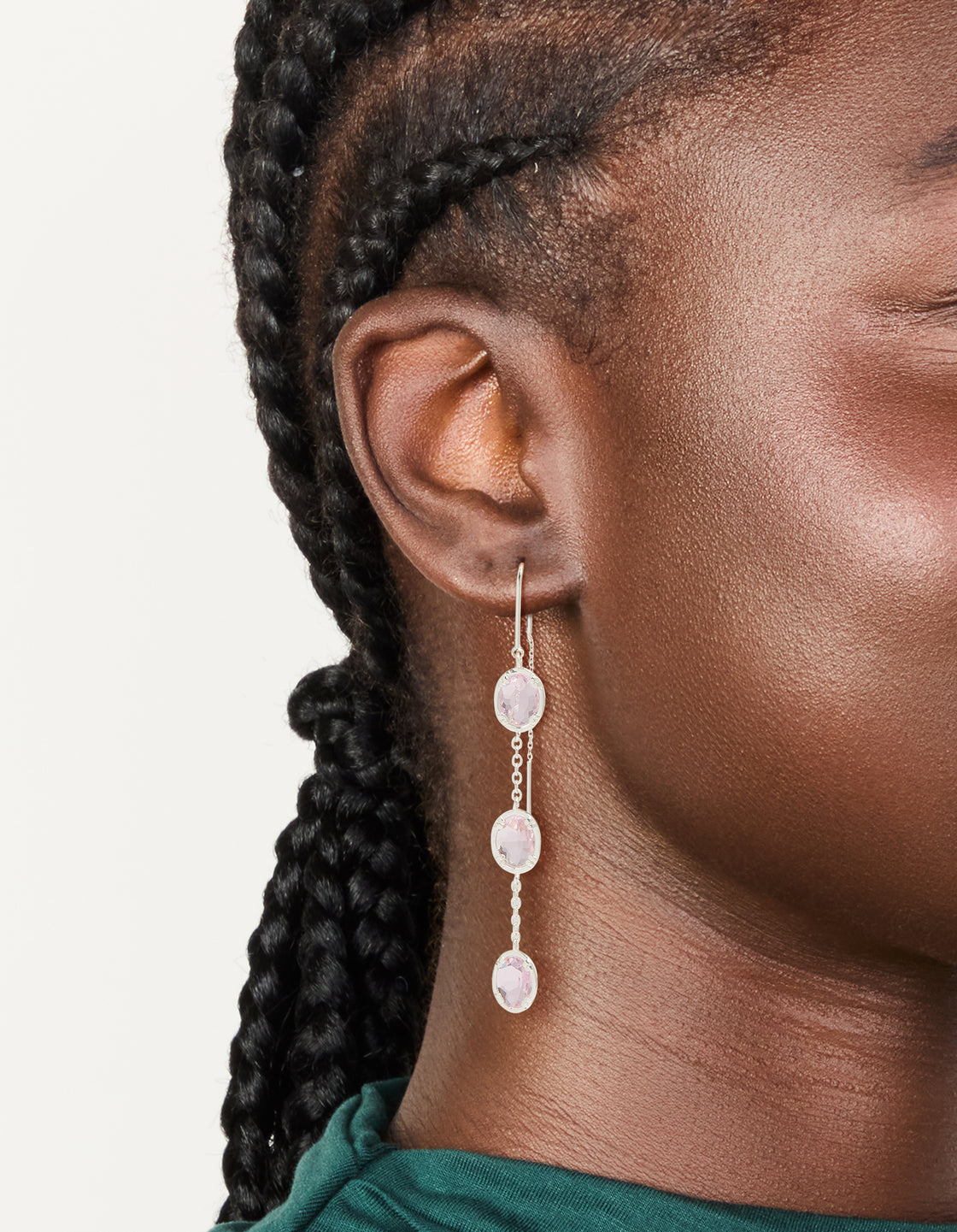 Showcasing silver plated pink stone thread through earrings with statement design on ear view