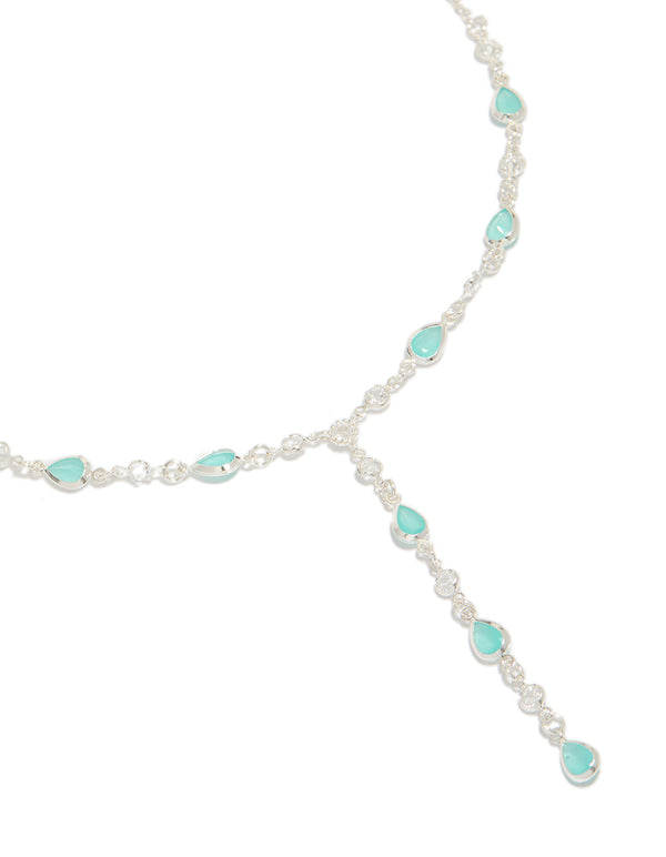 Showcasing a statement necklace crafted from silver plated metal with cubic zirconia oval stones in turquoise close up view