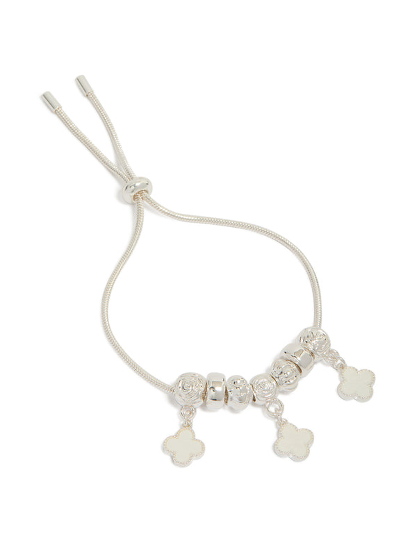 Featuring beads, floral charm design with toggle closure in silver plated triple clover drop bracelet front view