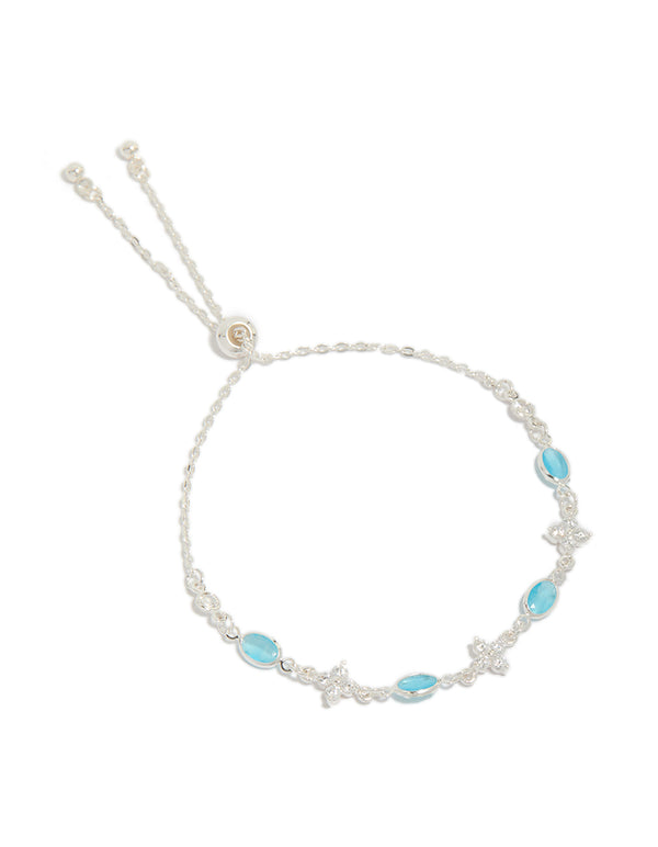 Introducing a silver plated cubic zirconia clover and blue oval bracelet turquoise accents and clear stones front