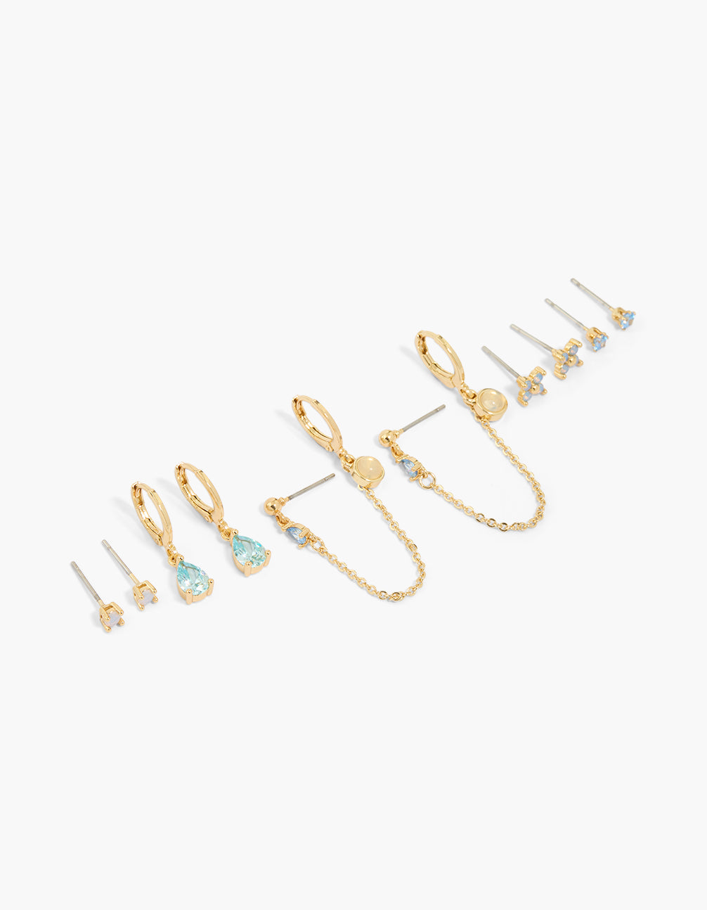 Showcasing gold plated blue cubic zirconia flower and bezel earrings in a 6-pack with floral crystal huggie stud closures front view