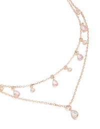 Showcasing a layered necklace with charm featuring pear stone pink and clear cubic zirconia in rose gold plated finish close up view - link has visual effect only