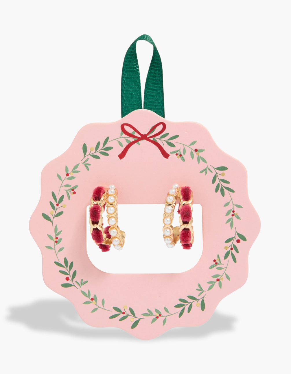 Showcasing gold red velvet look and pearl layered huggie earrings in white front view