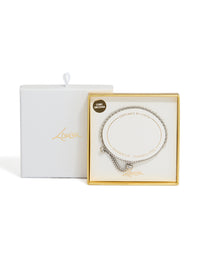 Featuring a waterproof stainless steel cubic zirconia tennis toggle bracelet in silver and clear close up view - link has visual effect only
