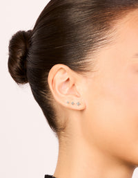 Showcasing sterling silver flower flat back stud earrings 3-pack with clear and silver on ear view - link has visual effect only
