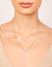 Showcasing a gold plated pink cubic zirconia flower trio necklace with floral in statement style on neck view - link has visual effect only