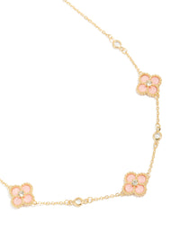 Beautifully crafted gold plated pink cubic zirconia flower trio necklace in a statement style close up view - link has visual effect only